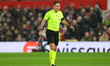 Referee Rade Obrenovic officiates during the UEFA Europa League Round of 16, 1st Leg match...