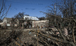 People walk past a building damaged by a Russian strike with guided aerial bombs in Zapori...