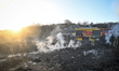 Rescue workers operate at the site of a fire that breaks out following a Russian strike wi...