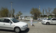 Vehicles drive past a joint police and Islamic Revolutionary Guard Corps (IRGC) checkpoint...