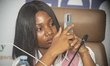 Felicia Odedeji, Managing Director of That BarberGirl Academy, records proceedings as Fide...