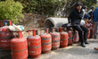 Nepali residents stand in line with empty LPG cylinders during a cooking gas shortage in K...