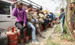 Nepali residents stand in line with empty LPG cylinders during a cooking gas shortage in K...