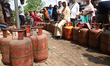 People wait in a long queue to buy liquefied petroleum gas (LPG) cylinders for domestic us...