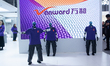 Robots perform dancing in front of the Vanward booth at the SNEIC Expo Center in Shanghai,...