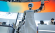 A robot dresses as a chef in front of the Robam appliance booth at the SNEIC expo center i...