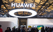 Fairgoers are seen at the Huawei booth at the SNEIC Expo Center in Shanghai, China, on Mar...