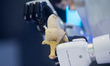 A robot peels a banana on the stage of the Haier booth at the SNEIC expo center in Shangha...