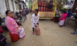 People stand in a long queue to collect LPG cylinders after information about availability...