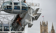 The London Eye and UK flag are seen on the street in London, United Kingdom, on February 1...