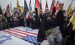 Pro-government demonstrators shout anti-U.S. and anti-Israeli slogans while gathering arou...