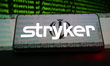 The Stryker Corporation logo appears on the screen of a smartphone placed on a reflective...