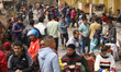 Nepali consumers wait in queue for their turn to take the half-filled gas cylinder at the...