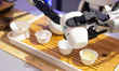 A robot demonstrates how to prepare tea at the JD booth during the second day of the Awe 2...