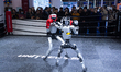 Boxing robots perform a boxing match at the Unitree booth during the second day of the AWE...