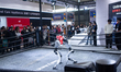 Boxing robots perform a boxing match at the Unitree booth during the second day of the AWE...