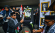 A crowd gathers under the banner of ''Bandung Protest--Artistic Solidarity for Palestine''...