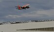 An EasyJet plane is in flight at Lyon-Saint Exupery Airport in France on March 13, 2026, d...