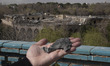 A man shows a piece of iron that he tells the media is part of an exploded Israeli rocket,...