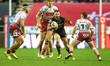 Andy Ackers runs at the Wigan defense during the BetFred Super League match between Wigan...