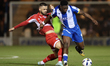 Geraldo Bajrami of Crawley Town (left) tackles Samson Tovide of Colchester United (right)...