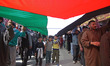 In Magam, Jammu and Kashmir, on March 13, 2026, Kashmiri Shiite Muslims carry the flag of...