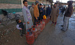 People queue at a gas agency amid LPG gas shortage fears in Jammu and Kashmir, India, on M...