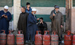 People queue at a gas agency amid LPG gas shortage fears in Jammu and Kashmir, India, on M...