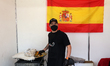A man, next to a Spanish flag, sells paella at the World Fair held in the External Plaza o...