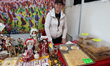 A woman sells products and typical Romanian food at the World Fair in the Plaza Externa of...