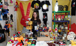 A woman sells products from Chile, including items from 31 Minutos, at the World Fair in t...