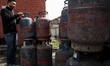 Commercial and domestic empty gas cylinders are at a gas agency in Sopore, Jammu and Kashm...