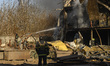 Firefighters work at an industrial facility damaged during a massive Russian missile and d...