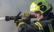 Firefighters work at an industrial facility damaged during a massive Russian missile and d...