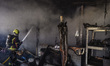 Firefighters work at an industrial facility damaged during a massive Russian missile and d...