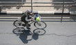 A man rides a bicycle along the Ring Road highway in Kathmandu Valley, Nepal, on March 14,...
