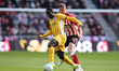 Yankuba Minteh of Brighton and Hove Albion is challenged by Daniel Ballard during the Prem...