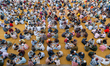 Muslim devotees gather in circles to share the iftar meal while breaking their day-long fa...
