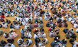 Muslim devotees gather in circles to share the iftar meal while breaking their day-long fa...