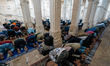 Muslim worshippers gather inside the historic mosque complex of Sarkhej Roza to perform th...