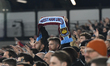 A West Ham fan holds a scarf during the Premier League match between West Ham United and M...