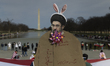 A protester holds a cardboard cutout depicting Mojtaba Khamenei wearing bunny ears during...