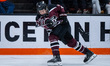 Lucas Buzziol of the Union Garnet Chargers passes the puck during an NCAA men's ice hockey...