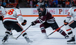 Tyler Dunbar of the Union Garnet Chargers possesses the puck while Joshua Karnish of the P...