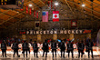 The Union Garnet Chargers and the Princeton Tigers stand for the national anthem before an...