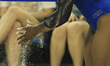 Jordan Chiles of the UCLA Bruins applies chalk to her hands before the floor routine again...