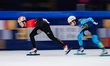 Zhu Yiding of China skates ahead of Aibek Nassen of Kazakhstan in the Men's 5000m Relay Se...