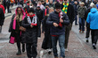 Manchester United fans make their way to Old Trafford during the Premier League match betw...