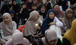 People gather at Istiqlal Mosque in Jakarta, Indonesia, to have iftar together provided by...