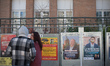 People look at electoral posters in Toulouse, France, on March 15, 2026. French citizens p...